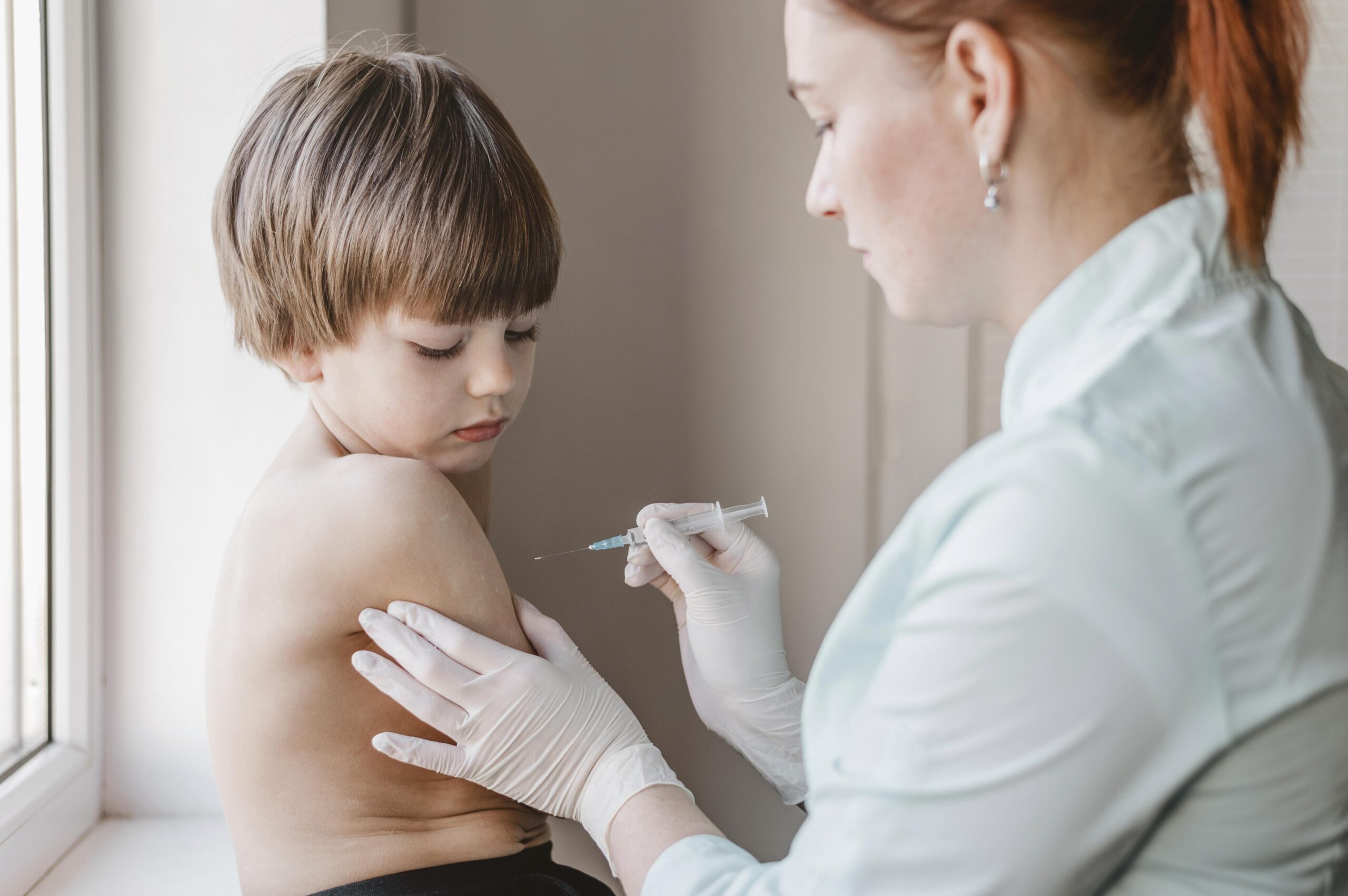 doctor with child getting vaccine 